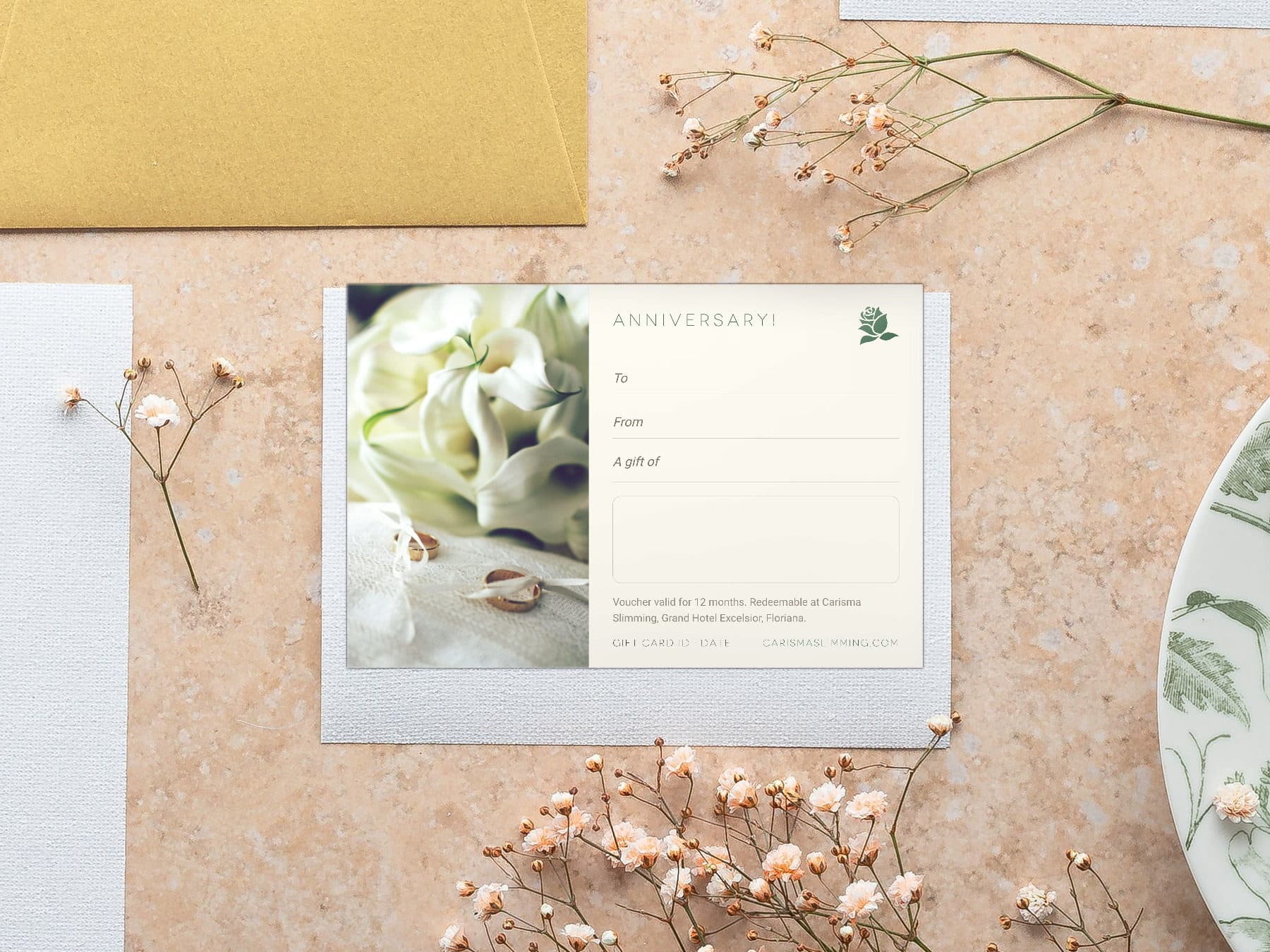 Anniversary Carisma Slimming gift card, styled flat-lay