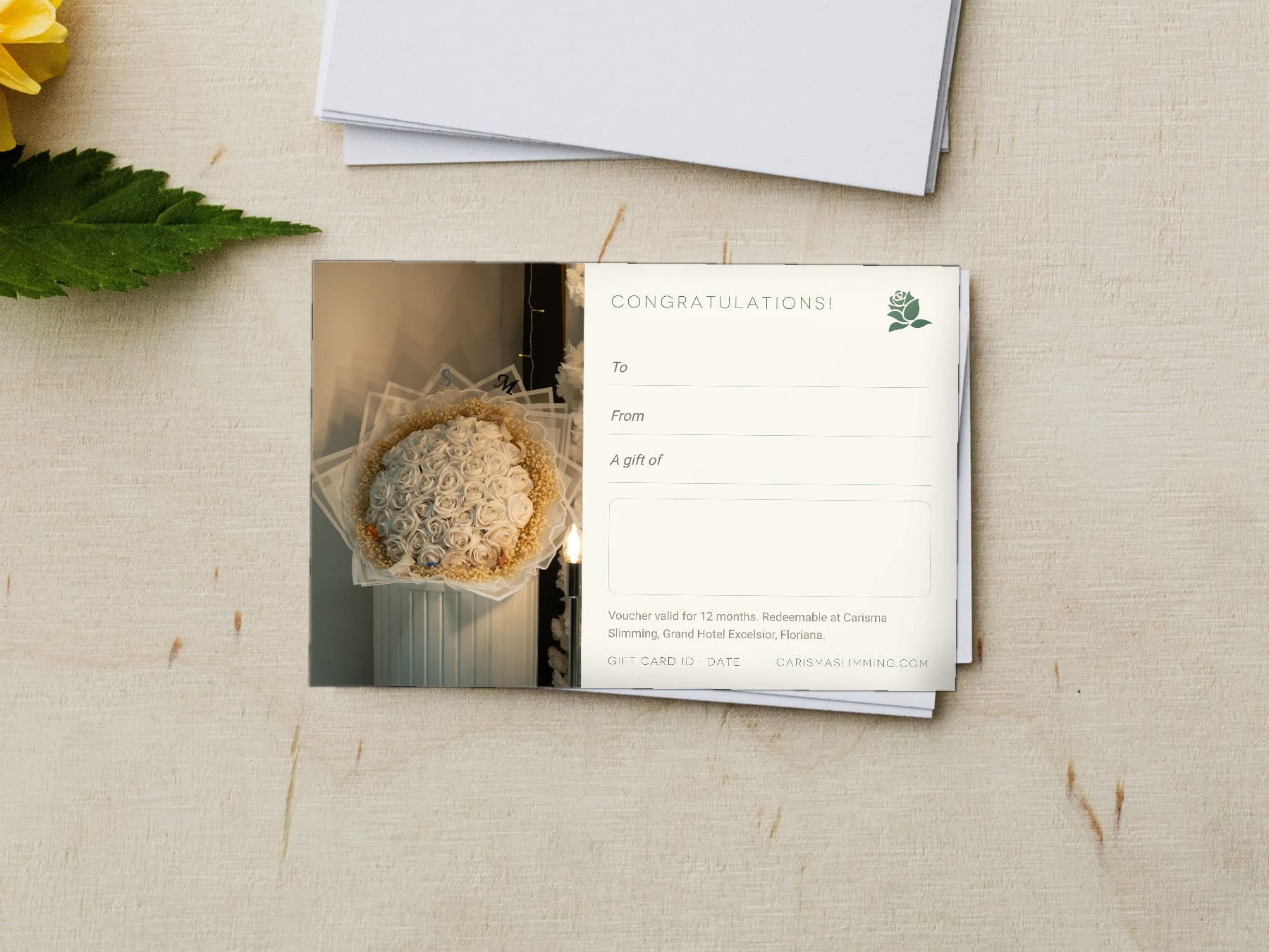 Congratulations Carisma Slimming gift card, styled flat-lay